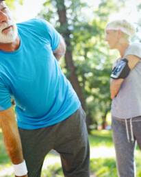 Mature man having a back pain during jogging