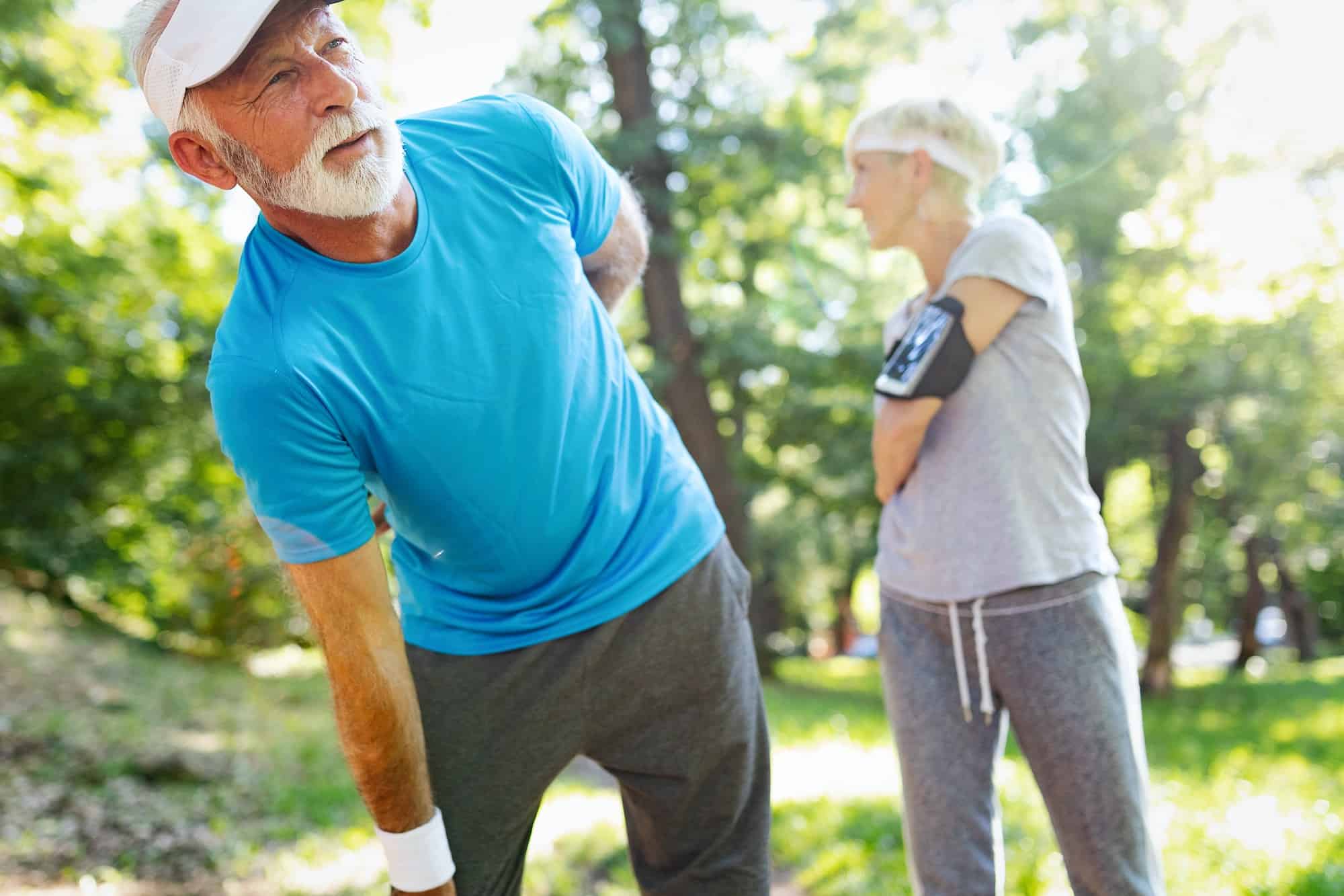 Mature man having a back pain during jogging