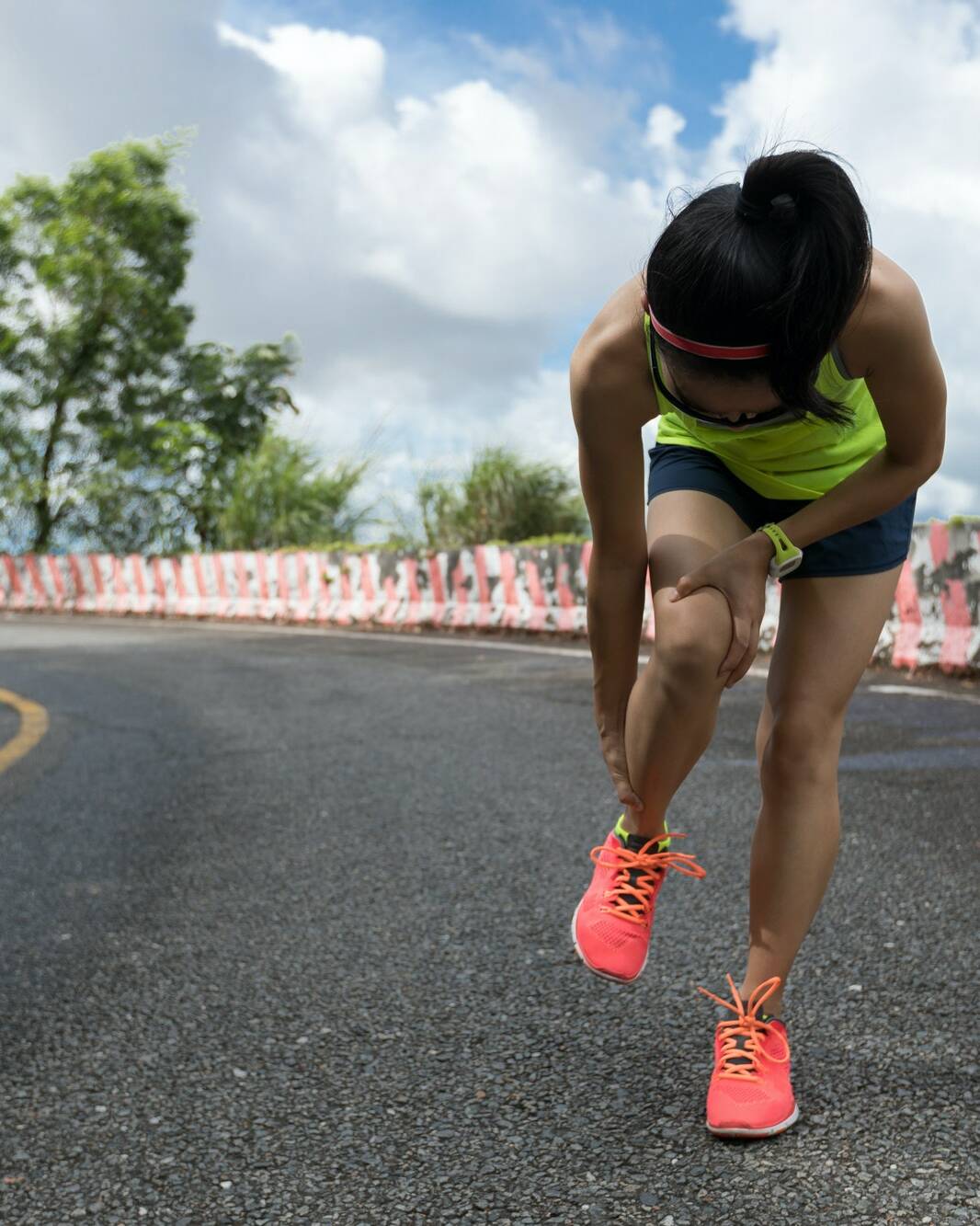 Woman runner suffering with pain on sports running knee injury